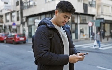Man using smartphone on the street