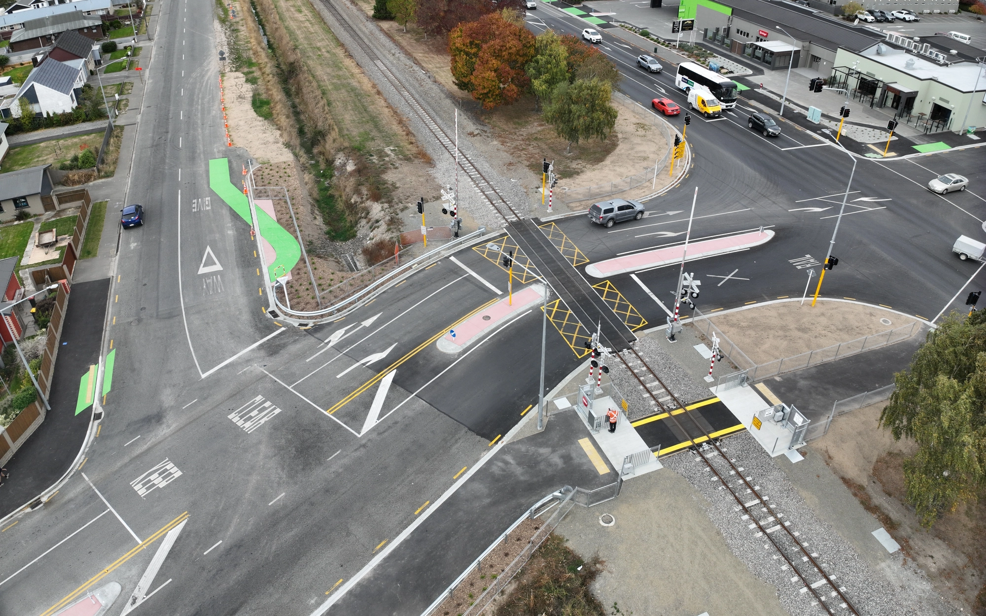 Road intersection with rail crossing and vehicles from above