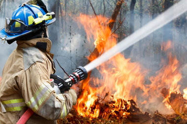 AdobeStock_68627725_a fireman suppresses the flames.jpg