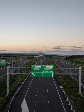 Motorway signs on the M12 with sculpture in the distance