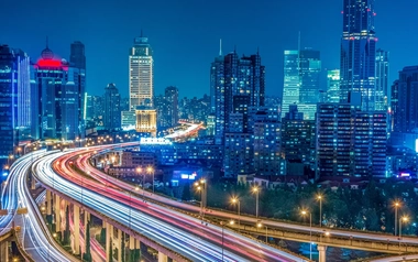 Aerial view of high-rise buildings and highway at night