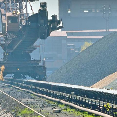 pile of coal and excavator