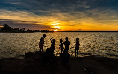 Silhouette of children by the sea
