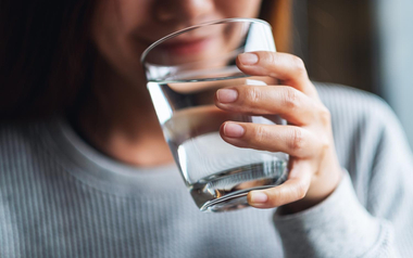 a woman drinking a glass of water
