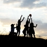 silhouette of kids playing ball