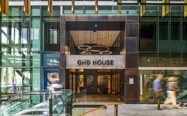 Entrance of GHD House with signage above a glass building entry.