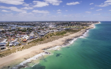 Aerial view of coastal suburb buildings shoreline and ocean in Greater Bunbury