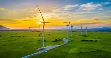 wind turbines against sunset