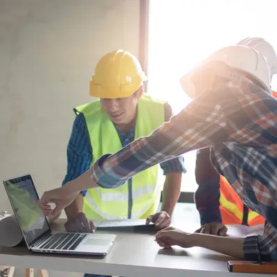 engineers checking plan on a laptop