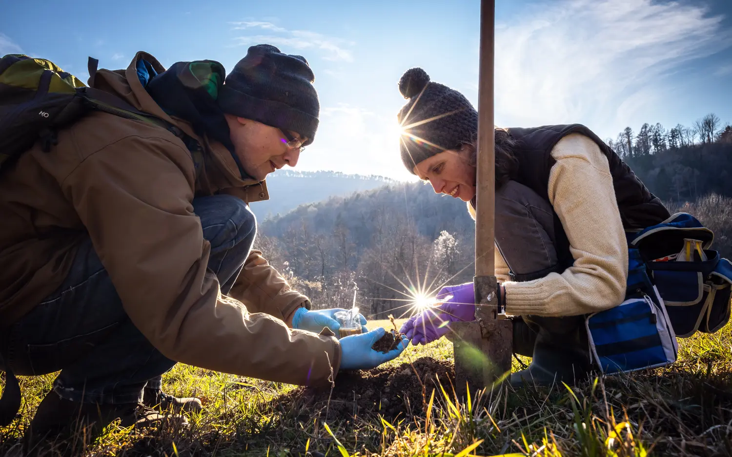 two field biologists testing soil