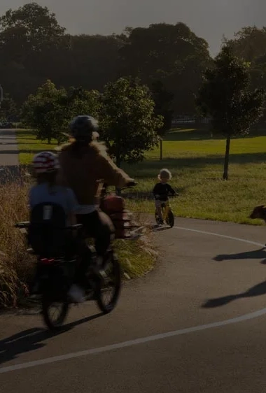 People-ride-bike-in-a-park.jpg