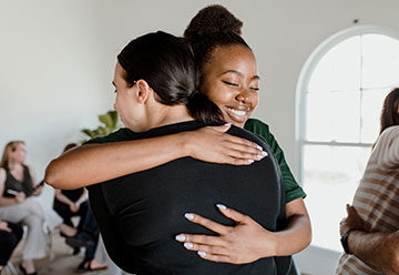 colleagues hugging each other