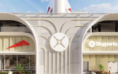 Front view of a modern vertiport in Dubai with curved white architecture, mesh facade panels and Skyports signage.