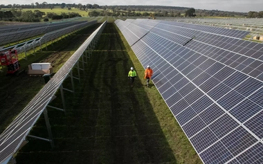 two workers work on the Solar farm.webp
