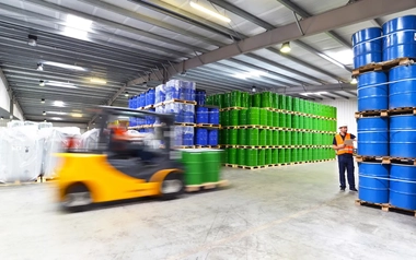 green and blue barrels organized in a warehouse