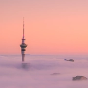 AdobeStock_570221021_CitySkylineAboveFogAtSunset