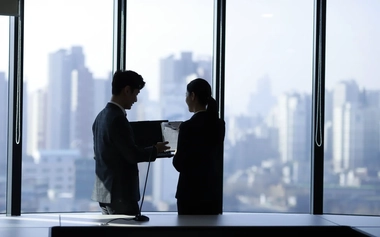 Business people holding a laptop