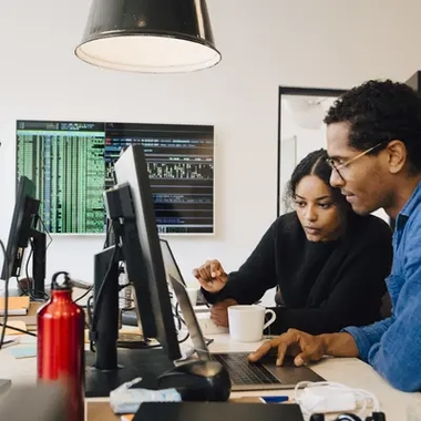 Focused engineers coding in office