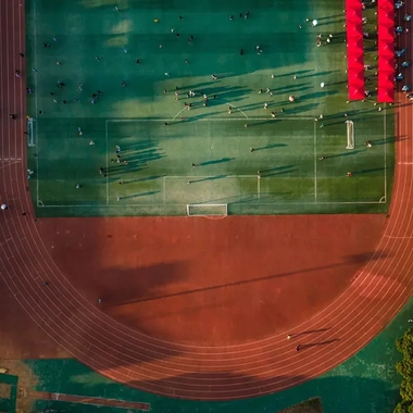 AdobeStock_636426681_Aerial-view-of-a-large-running-track-surrounded-with-lush-greenery