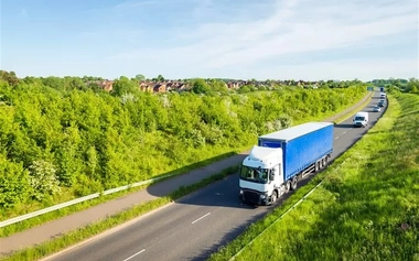 HGV (Heavy Goods Vehicle) on a road surrounded by greenery