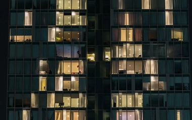 View of building and lit rooms at night