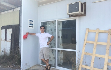 Dragan Jovanovic standing outside a building under construction.