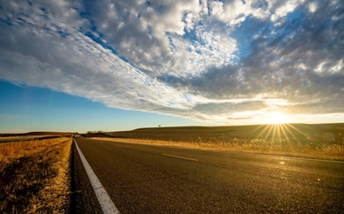 A cloudy day with sunrise while in a road