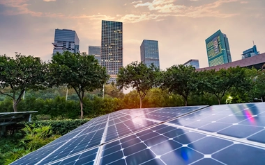 solar panel in front of skyline of city