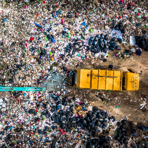 Aerial view garbage truck unload garbage to a landfill