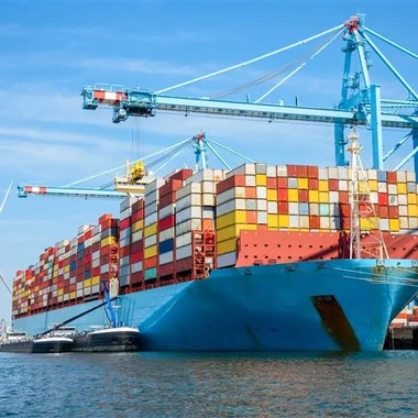 Container vessel docked at a modern port terminal