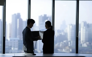 Business people using laptop in meeting