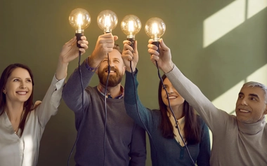 Group of people holding electric bulbs