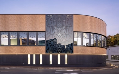 Curved building facade with glass panel and horizontal panel cladding