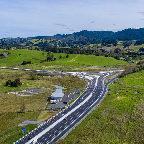 Aerial view of motorway interchange through green farmland