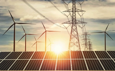 solar panels in the foreground, wind turbines in the background