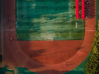 AdobeStock_636426681_Aerial-view-of-a-large-running-track-surrounded-with-lush-greenery