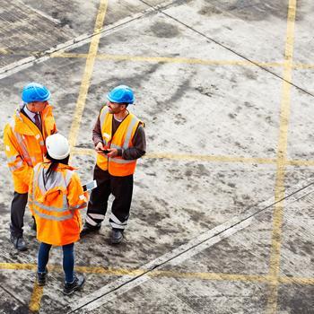 Construction workers talking at a site