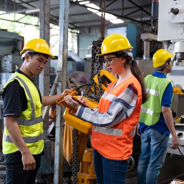  female safety engineer conducting a machine inspection