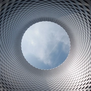 AdobeStock_605606882_an-architectural-marvel-where-circular-patterns-and-aluminum-panels-weave-a-mesmerizing-tapestry-around-a-central-void