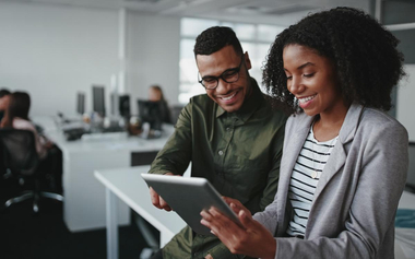Shot of two businesspeople using a digital tablet in the office
