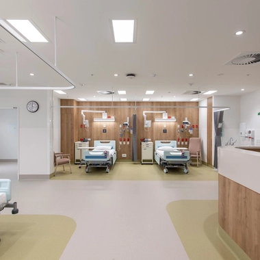 Hospital ward with two beds and medical equipment in a clean room