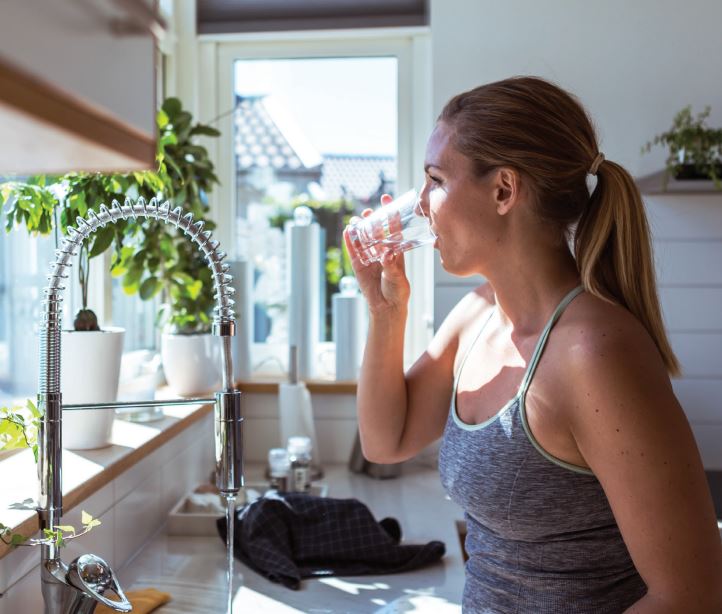 woman drinking a glass of water