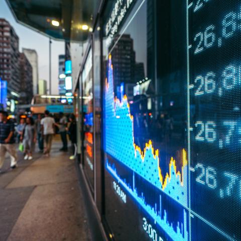 stock market figures displayed on a screen