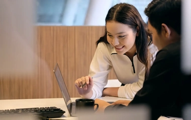 young graduate worker talking with other team member 