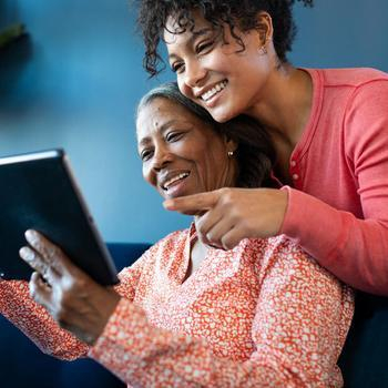 mother and daughter watching on a tablet