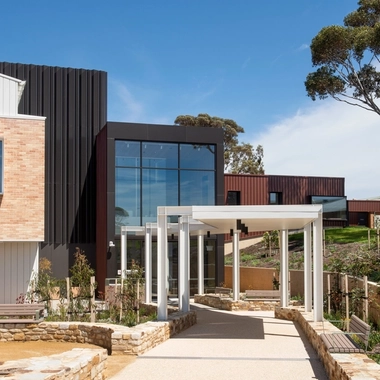 Hospital exterior with pathway landscaping and covered entrance