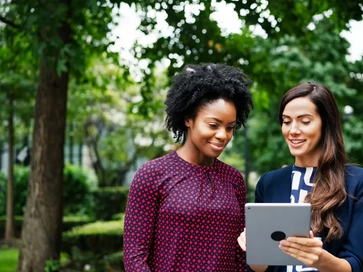 GettyImages-1089345334_two women watching a tablet.jpg