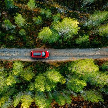  red car driving in a mountain
