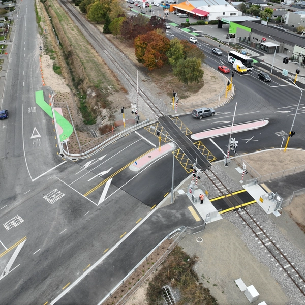 Aerial view of road intersection with rail crossing and traffic signals