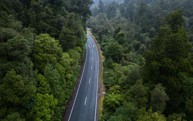 Aerial view of a road through forest terrain